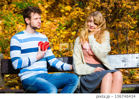 Man show feelings to girl in autumnal park. Man show feelings to girl in autumnal park. 136748434