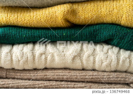 A stack of knitted sweaters on the table. Background textures A stack of knitted sweaters on the table. Background textures 136749468