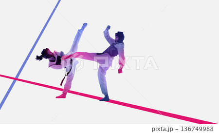 Powerful composition taekwondo athletes performing high kick. 136749988