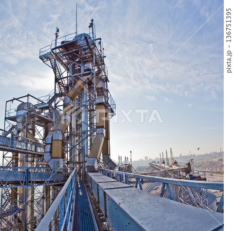 Industrial complex for grain processing with steel silos and conveyor systems. 136751395