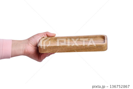 Female hand holding empty wooden tray on isolated background Female hand holding empty wooden tray on isolated background 136752867