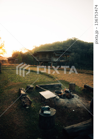 Traditional wooden stilt house in rural mountain farm during golden sunrise Traditional wooden stilt house in rural mountain farm during golden sunrise 136753474