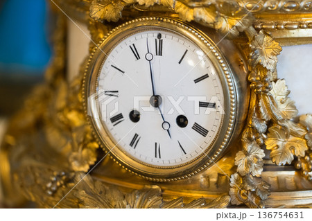 Antique gilded mantel clock closeup photography Antique gilded mantel clock closeup photography 136754631