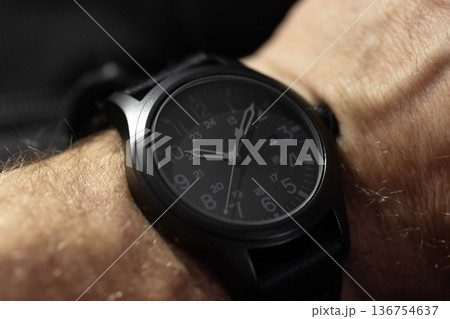 Close-up shot of a black tactical analog wristwatch 136754637