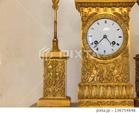 A close-up of an antique gilded mantel clock A close-up of an antique gilded mantel clock 136754646
