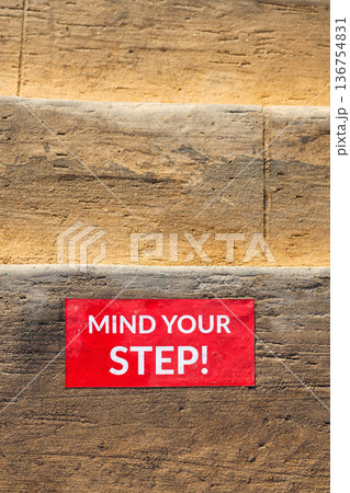 The inscription on the steps of the stairs reads Watch your step The inscription on the steps of the stairs reads Watch your step 136754831