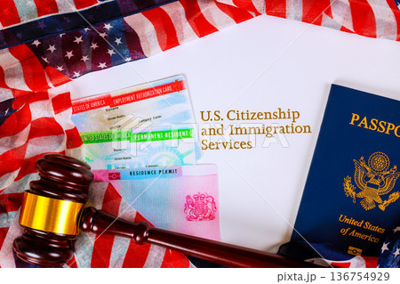 Documents for citizenship immigration services placed on table with laws gavel, American flags. Documents for citizenship immigration services placed on table with laws gavel, American flags. 136754929