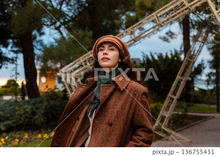 Young woman in a coat explores the city alone, expressing quiet emotion and mental focus. 136755431