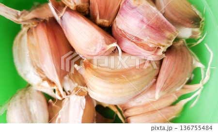 Garlic on green background. 136755484
