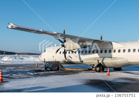 Close-up of the white passenger turboprop airplane on the winter airport 136755751