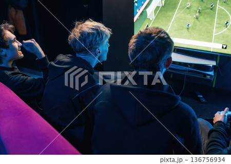 Close up view of hands of gamers that playing game on console Close up view of hands of gamers that playing game on console 136756934