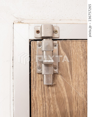 Stainless Steel Slide Bolt Latch on Wooden Door. 136757265