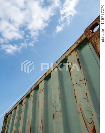 Old Rusted Shipping Container Against Blue Sky. 136757270