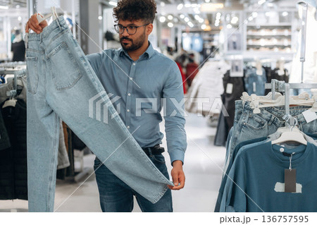 Big choice. Man customer is in the clothing store 136757595