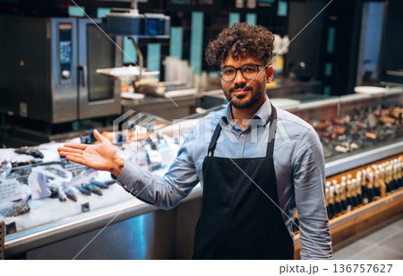 Male worker is in the grocery store Male worker is in the grocery store 136757627