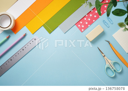 Creative workspace for DIY projects. Colorful stationery and craft supplies on blue background. Copyspace. Creative workspace for DIY projects. Colorful stationery and craft supplies on blue background. Copyspace. 136758078