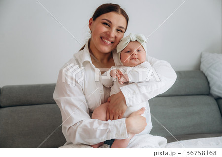 Woman is with her little toddler baby daughter Woman is with her little toddler baby daughter 136758168