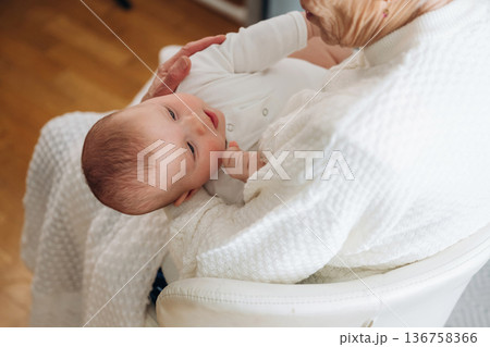 Wellness, holding kid. Grandmother with cute toddler baby at home Wellness, holding kid. Grandmother with cute toddler baby at home 136758366