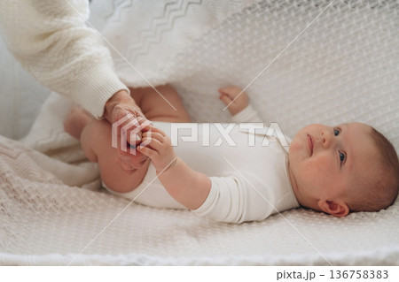 Senior woman is holding hands with little baby Senior woman is holding hands with little baby 136758383