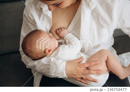 Breast feeding. Woman is with her little toddler baby daughter 136758477