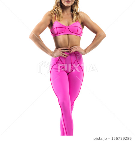 Athletic woman posing in pink sports bra and leggings with transparent background 136759289