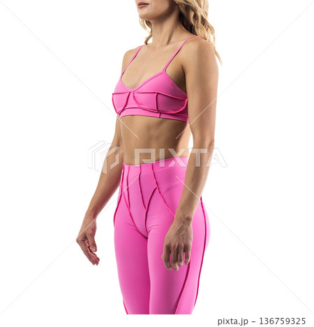 Athletic woman posing in pink sports bra and leggings with transparent background 136759325