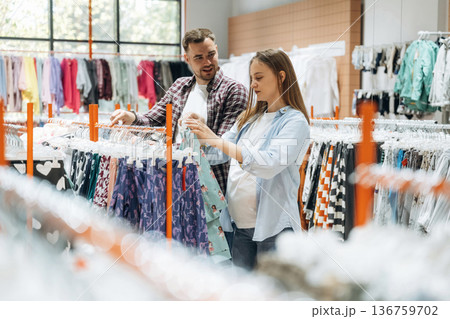 Together in the in the kid's clothing store. Pregnant woman with man 136759702