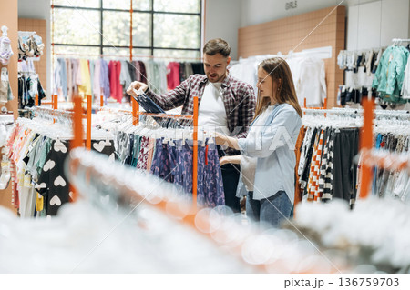 Together in the in the kid's clothing store. Pregnant woman with man 136759703