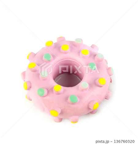 Pink donut-shaped rubber dog toy with colorful bumps isolated on white 136760320