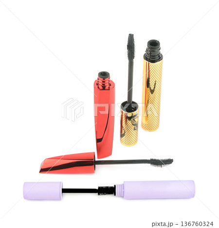 Mascara wands and containers in red gold and lilac colors Mascara wands and containers in red gold and lilac colors 136760324