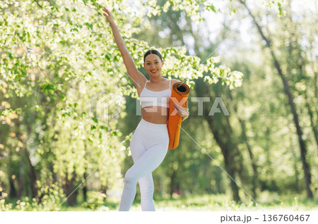 Enjoying nature, standing. Beautiful fitness yoga woman is outdoors, amazing nature Enjoying nature, standing. Beautiful fitness yoga woman is outdoors, amazing nature 136760467