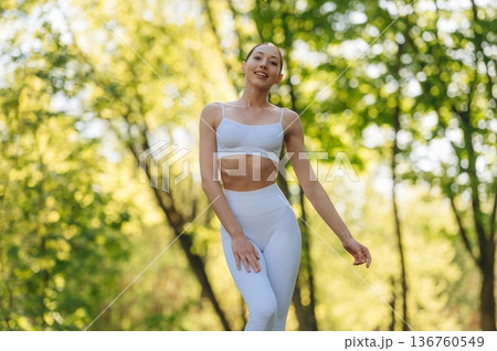 In fitness clothes. Beautiful yoga woman is outdoors, amazing nature 136760549