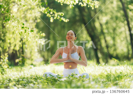 Smiling, positive facial expression. Beautiful fitness yoga woman is outdoors, amazing nature Smiling, positive facial expression. Beautiful fitness yoga woman is outdoors, amazing nature 136760645