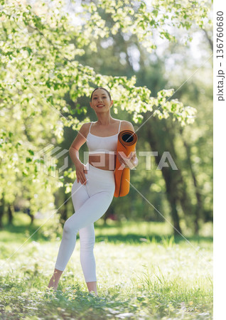 Enjoying nature, standing. Beautiful fitness yoga woman is outdoors, amazing nature Enjoying nature, standing. Beautiful fitness yoga woman is outdoors, amazing nature 136760680