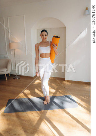 In the domestic room. Young woman in fitness clothes 136761240
