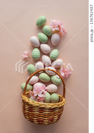 Easter Basket with Pastel Eggs, Flowers and Bunny Decorations. Festive Spring Flatlay Easter Basket with Pastel Eggs, Flowers and Bunny Decorations. Festive Spring Flatlay 136762487