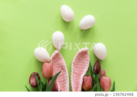 Easter Eggs with Bunny Ears and Tulips on Green Background. Spring Holiday Composition 136762498
