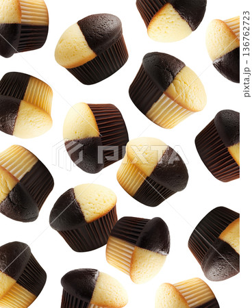 Delicious chocolate and vanilla muffins scattered seamless pattern isolated on white background, concept of dessert variety 136762723