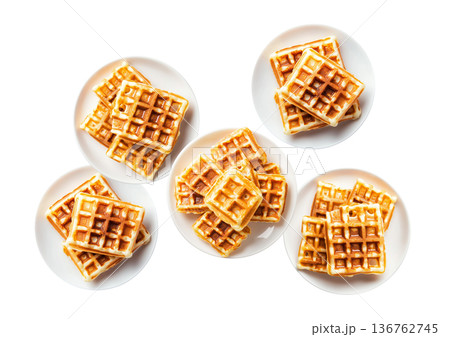 Multiple plates of golden waffles with creamy topping isolated on white background, concept of delicious breakfast food Multiple plates of golden waffles with creamy topping isolated on white background, concept of delicious breakfast food 136762745