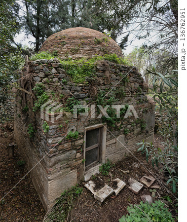 Overgrown Aydinogullari Turbe Tomb with brick dome near Temple of Artemis column, Selcuk Turkey 136762951