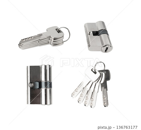 Keys and lock cylinder for door lock isolated. Pin tumbler components ready to replace or repair Keys and lock cylinder for door lock isolated. Pin tumbler components ready to replace or repair 136763177