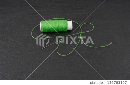 Needle and thread. Needlework object, color cotton thread spool and needle 136763197