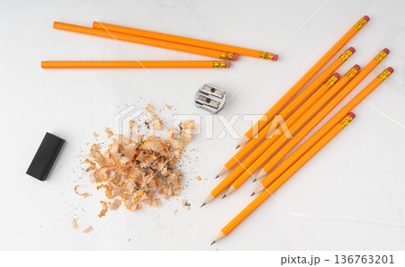 Sharpening pencils isolated. Yellow wooden graphite pencils with erasers, pencil shavings Sharpening pencils isolated. Yellow wooden graphite pencils with erasers, pencil shavings 136763201