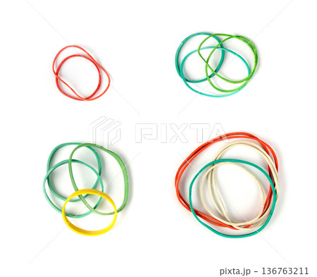 Rubber band isolated. Elastic rubberband bracelets pile, plastic flexibility circles Rubber band isolated. Elastic rubberband bracelets pile, plastic flexibility circles 136763211