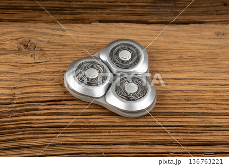 Electric shaving head on retro wood table 136763221