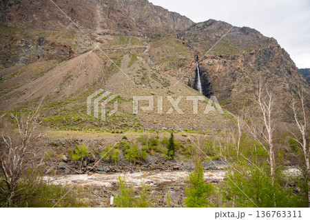 Mountain cliffs surrounding Chulyshman valley with visible waterfall Altai Russia Dramatic natural landscape with high rocks and falling water 136763311
