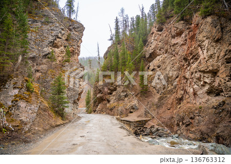 Red Gates canyon entrance on gravel road in Altai Russia. Natural rock formation gateway between cliffs 136763312