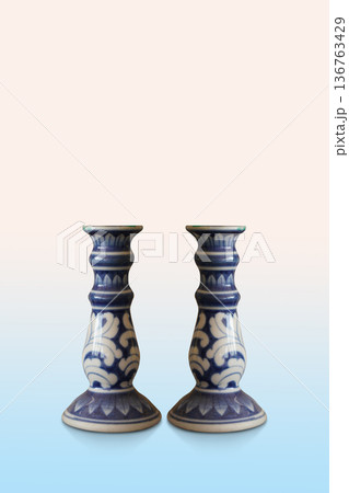 beautiful two white and blue ceramic candle holders on pink and blue background, decor, fashion, object, religion, copy space beautiful two white and blue ceramic candle holders on pink and blue background, decor, fashion, object, religion, copy space 136763429