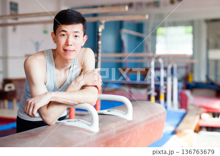 Portrait of asian gymnast in gym near pommel horse Portrait of asian gymnast in gym near pommel horse 136763679