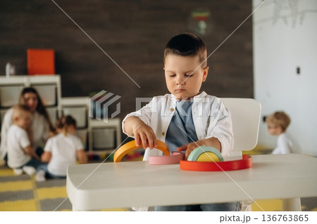 Motor skills, playing a game. Group of children are in the kindergarten Motor skills, playing a game. Group of children are in the kindergarten 136763865